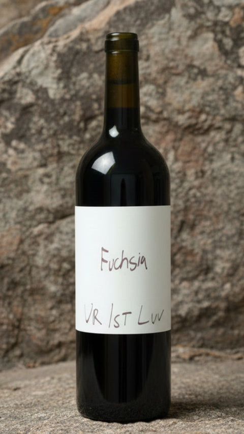 Wine bottle with a white label on a stone surface